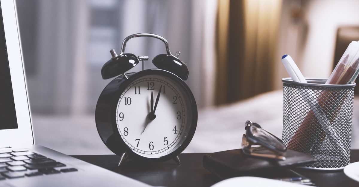 Clock on a desk showing late evening hours