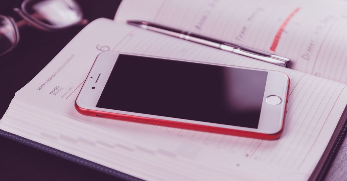 Person booking an appointment on a calendar app on a smartphone