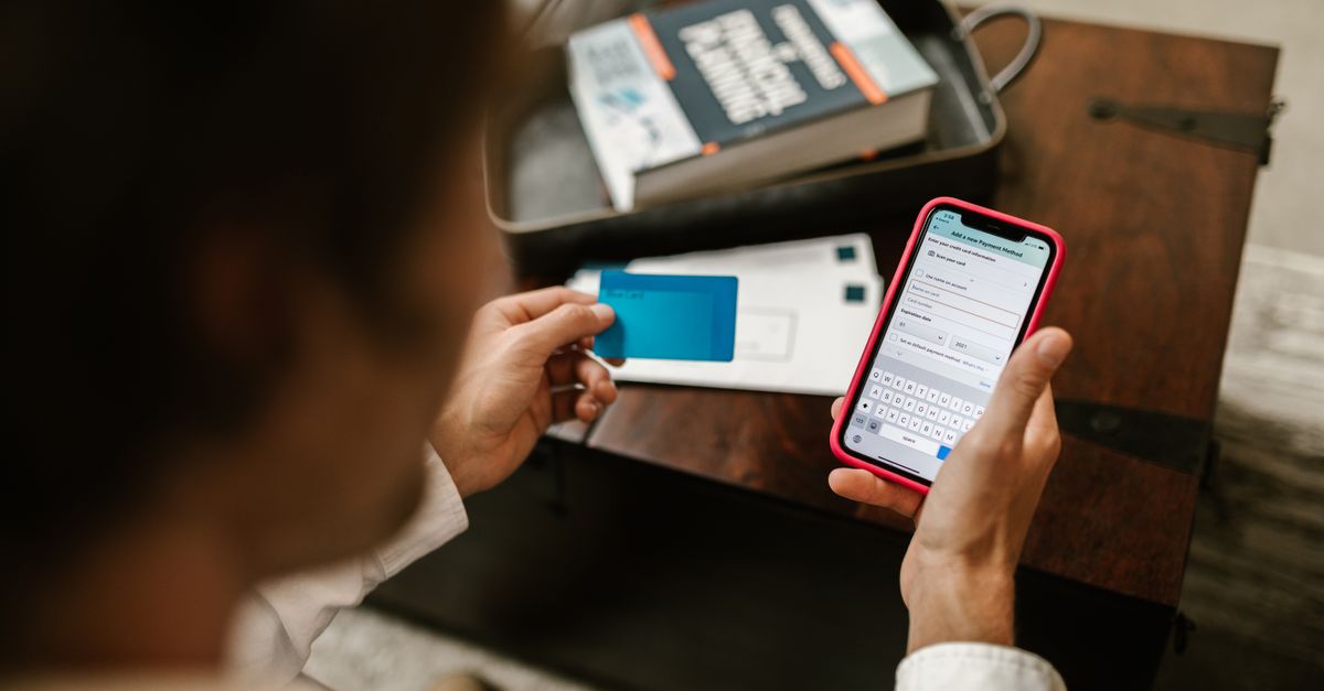 Customer confirming a booking on a mobile phone with a coffee