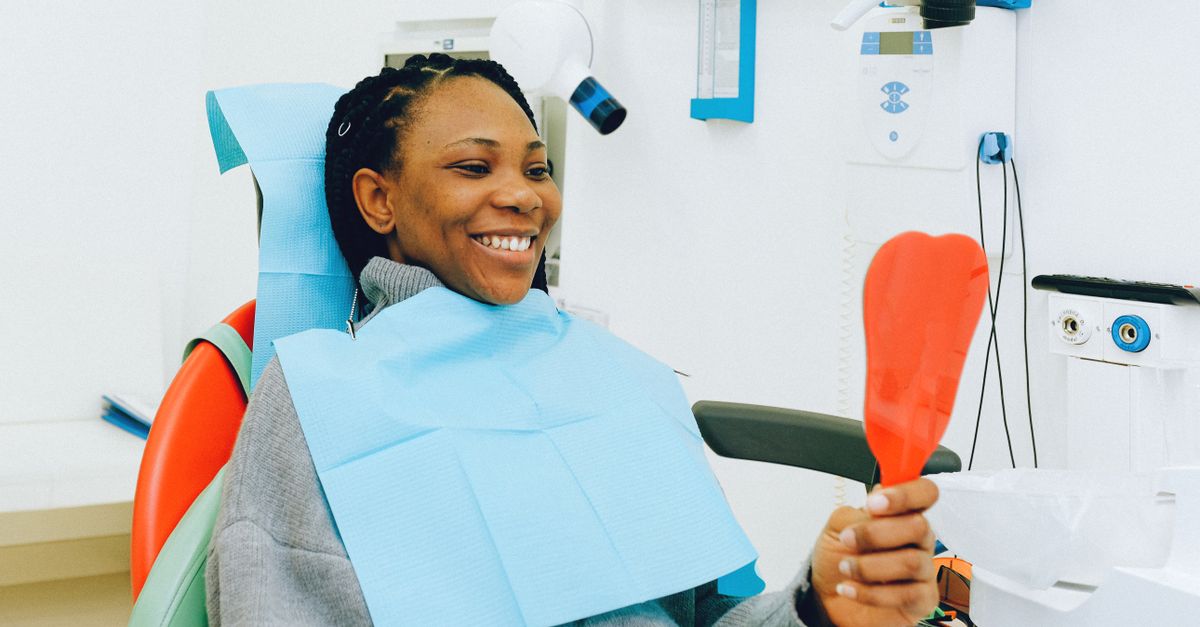 Patient smiling in a dentist's chair during a checkup