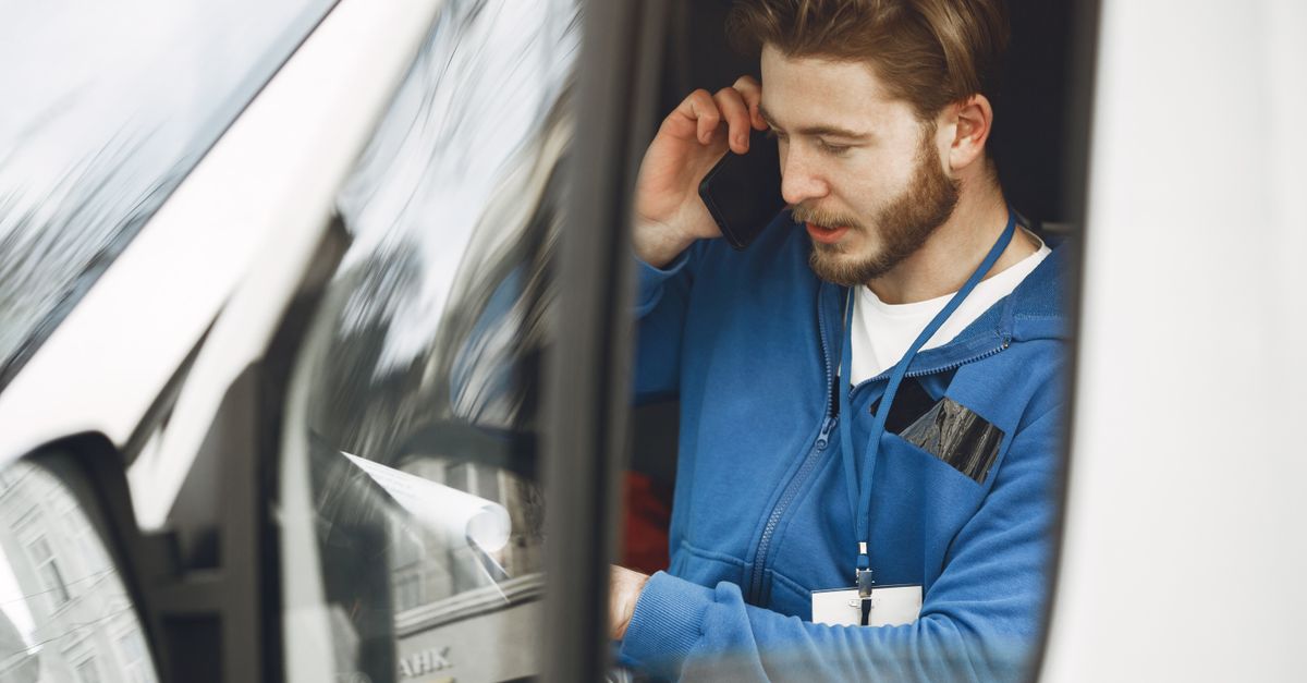 Tradesperson taking a call from a service van