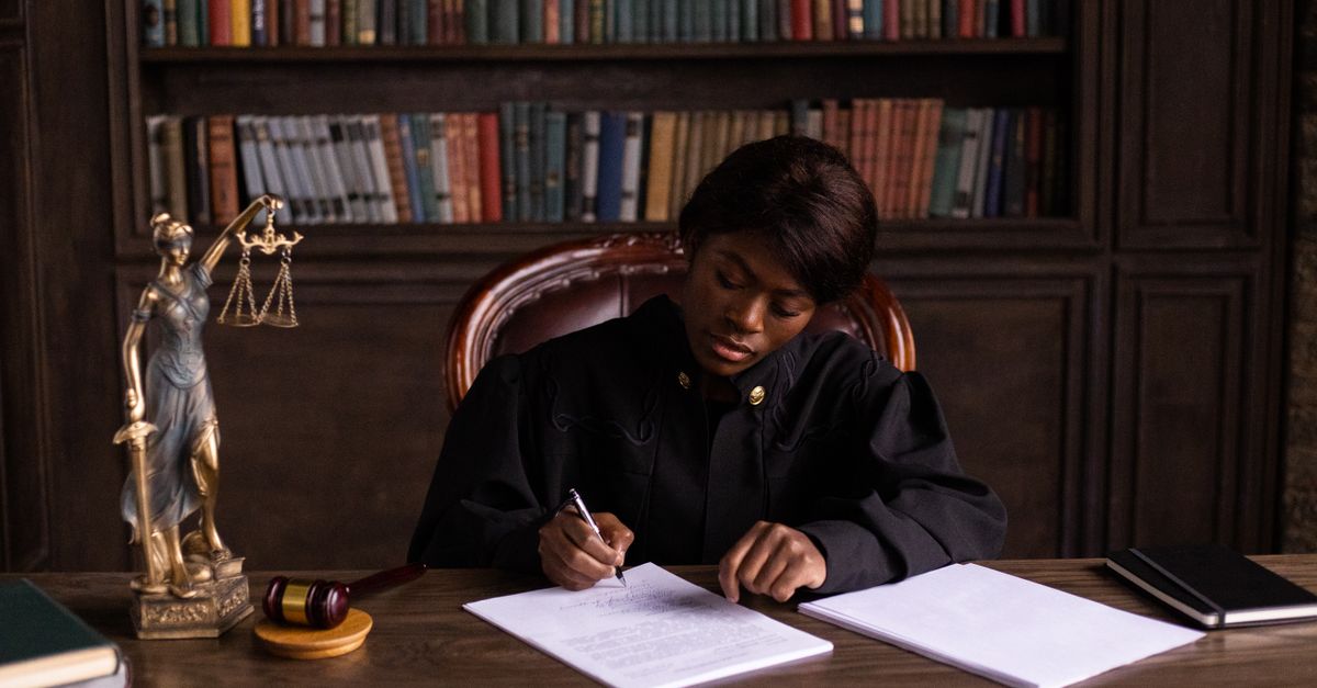 Law office with books and a gavel on a wooden desk
