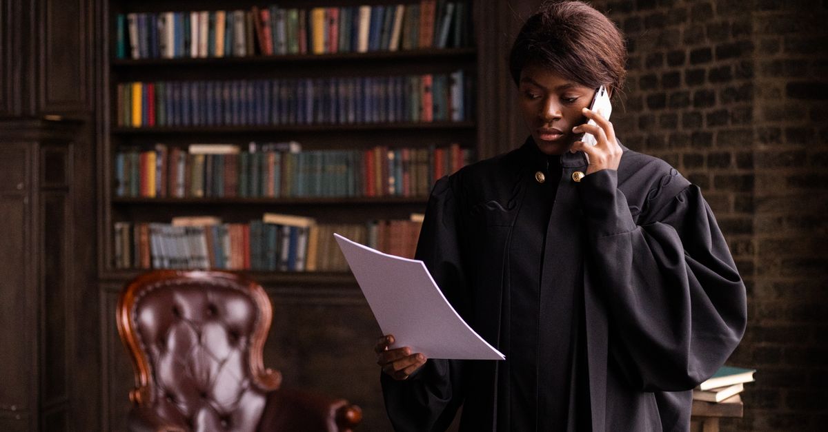 Attorney reviewing documents while on a phone call