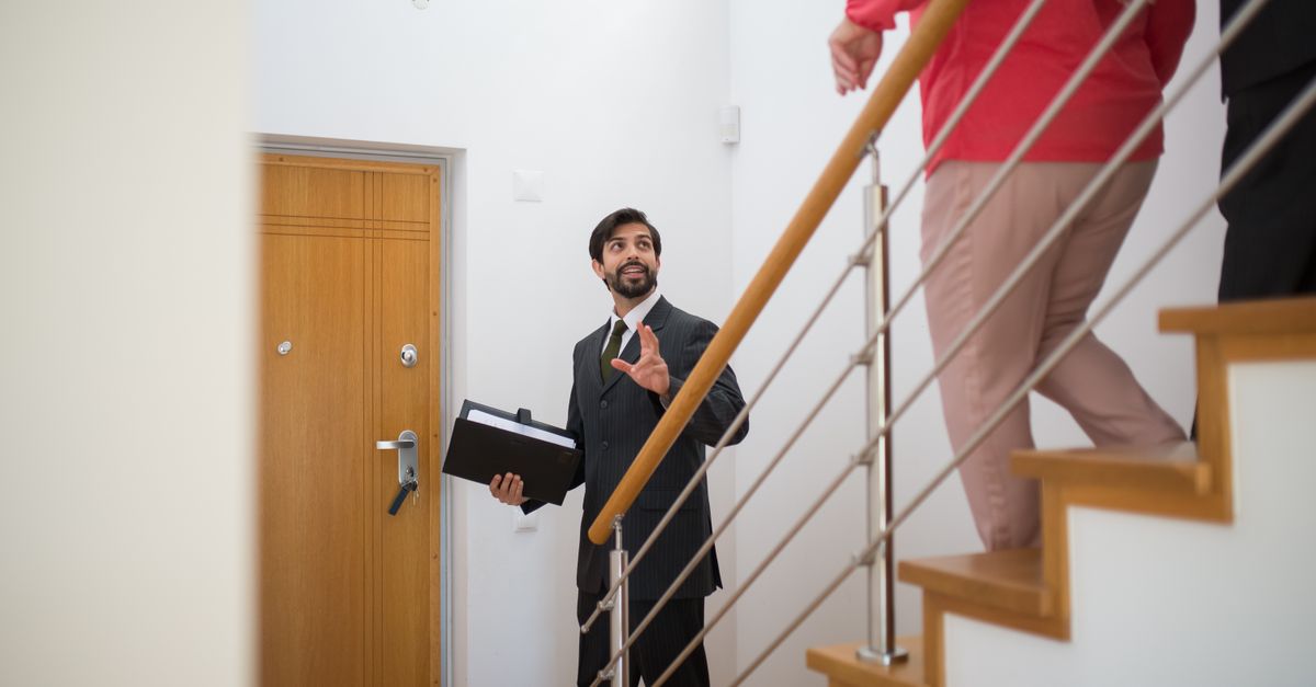 Real estate agent showing a house to a couple