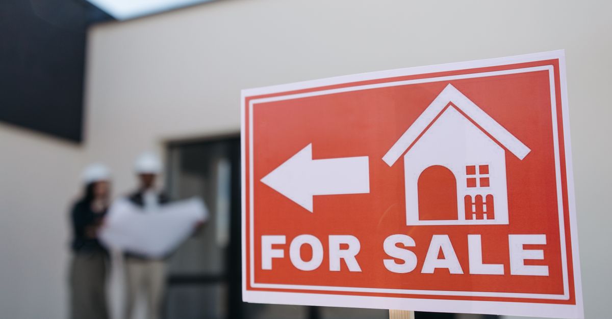 For sale sign in front of a modern home