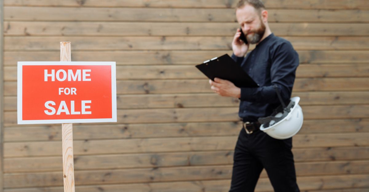 Agent talking on the phone while looking at listings on a laptop