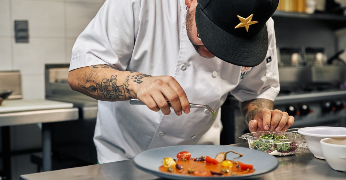 Chef plating a dish in a professional kitchen