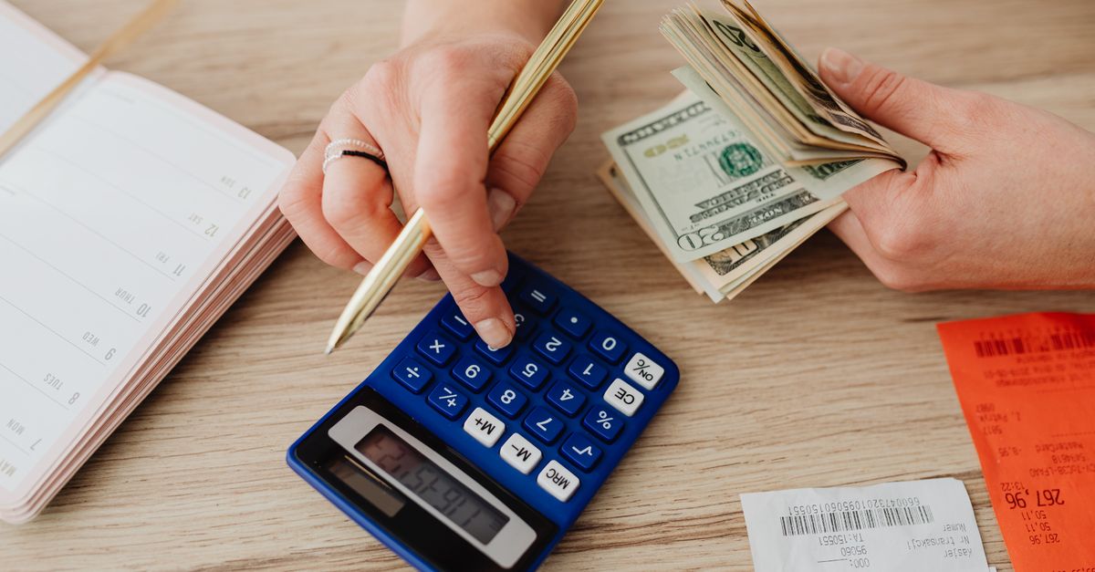 Calculator, pen, and notepad used to plan a business budget