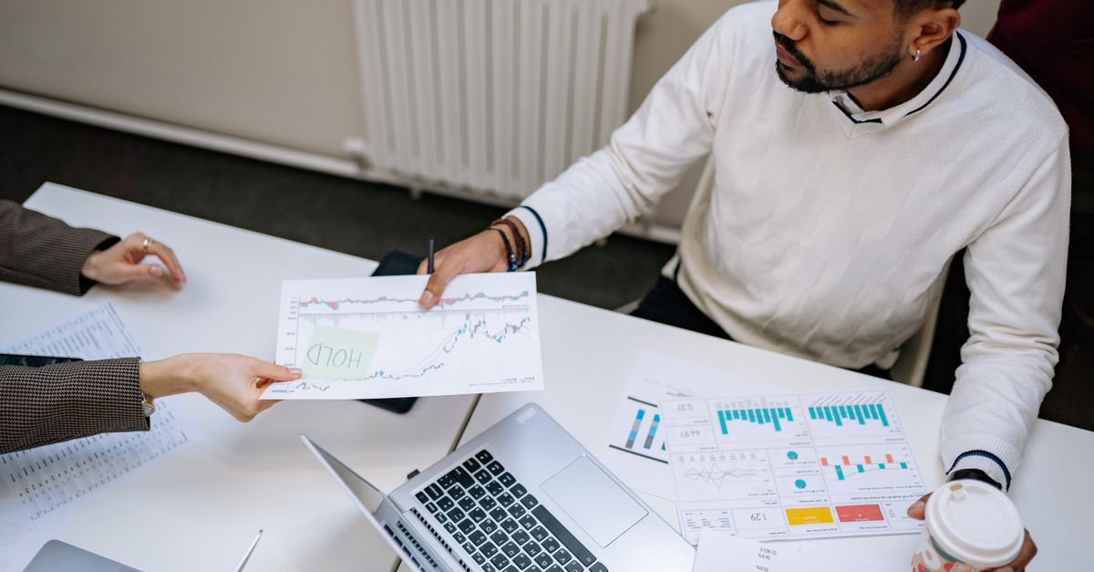 Business owner reviewing financial charts on a laptop