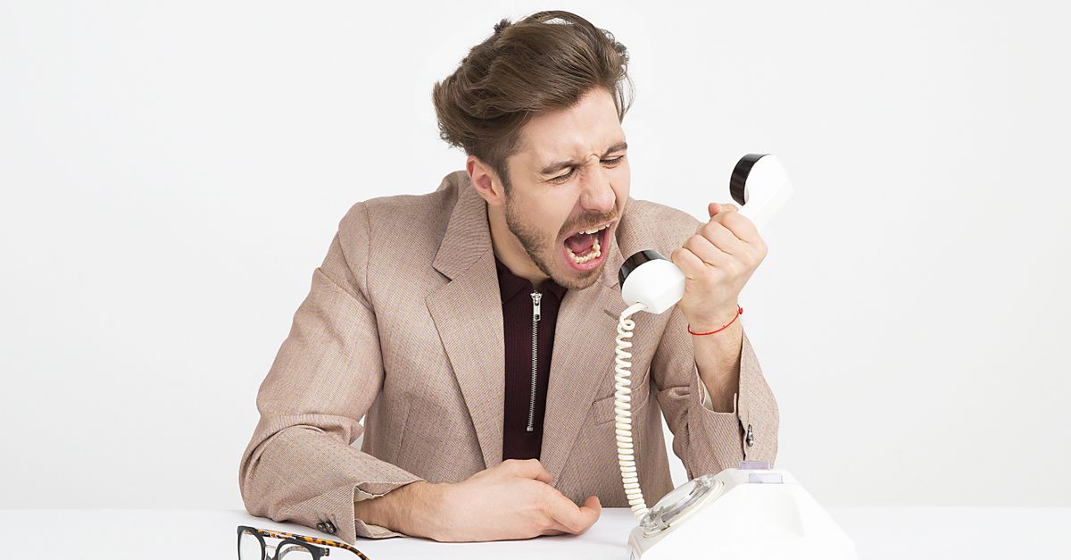 Customer looking frustrated while waiting on hold
